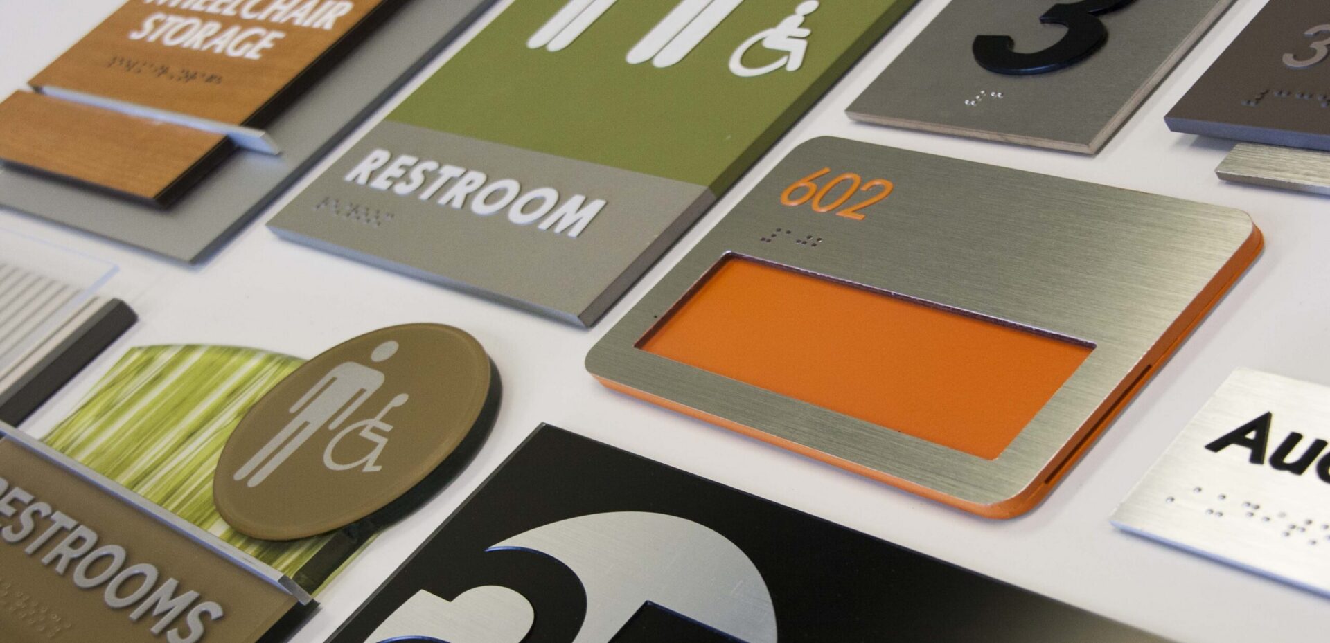 ADA Signs closeup detail showing variety of styles materials and shape options