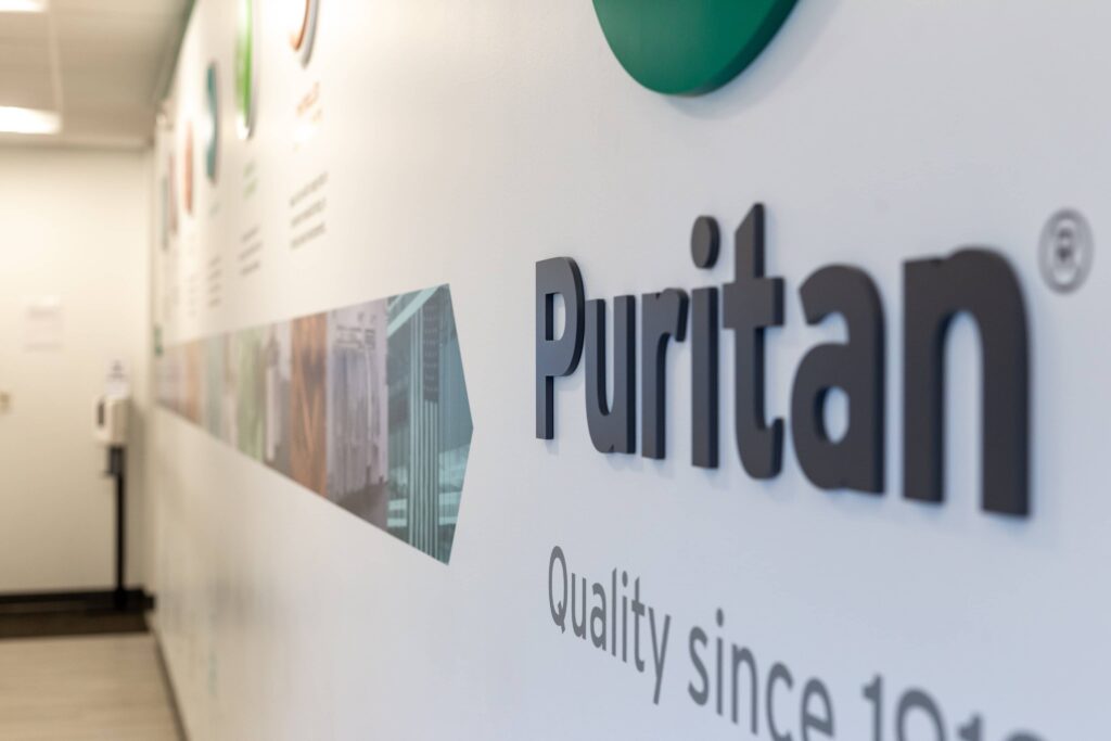 puritan logo closeup on history wall