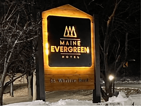 maine evergreen hotel reverse halo-lit exterior sign at night